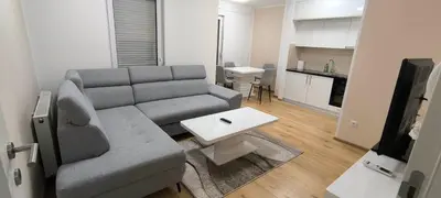 a living room with a couch and a table at City apartman Modrica in Modriča