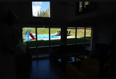 a room with a view of a swimming pool through a window at Villa Uno Momento in Sreće