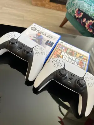 two video game controllers sitting on top of a table at Villa Uno Momento in Sreće