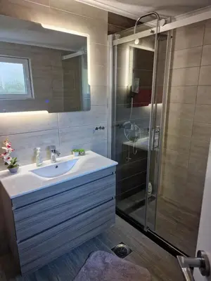 a bathroom with a sink and a shower at Villa Uno Momento in Sreće