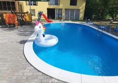 a swimming pool with a unicorn float in it at Villa Uno Momento in Sreće