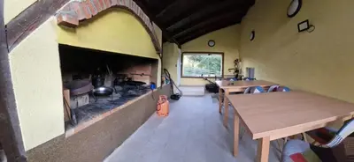 a room with a fireplace and tables in a room at Villa Uno Momento in Sreće