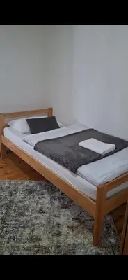 a bed sitting on top of a rug at Kuća za odmor Kukavičko jezero in Kupres
