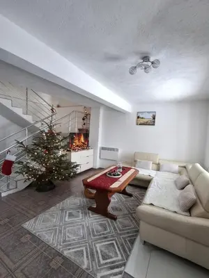 a living room with a christmas tree and a couch at Kuća za odmor Kukavičko jezero in Kupres