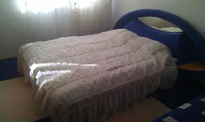 a bed in a room with a bed frame at Apartman Kupres u centru grada in Kupres