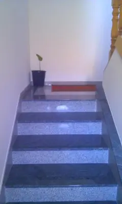 a set of stairs with a potted plant on them at Apartman Kupres u centru grada in Kupres