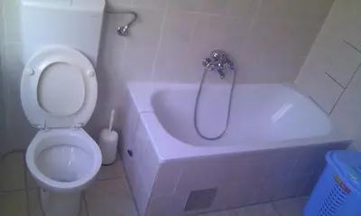 a bathroom with a toilet and a tub with a shower at Apartman Kupres u centru grada in Kupres