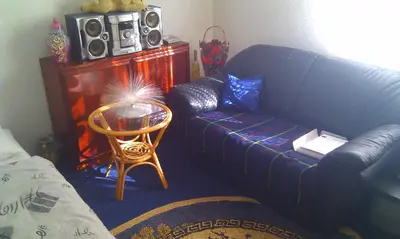 a living room with a couch and a table at Apartman Kupres u centru grada in Kupres