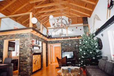 a living room with a christmas tree and a couch at Planinska kuća Ema in Kupres