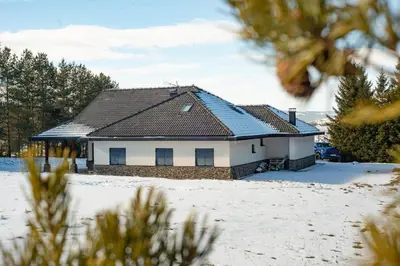 a house with a roof in the snow at Planinska kuća Ema in Kupres