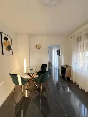 a dining room with a glass table and chairs at Kastel Apartmani in Banja Luka