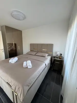 a bedroom with a bed with two towels on it at Kastel Apartmani in Banja Luka