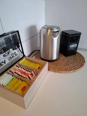 a counter with a coffee pot and a box of matches at Apartman MAX sa privatnim parkingom in Banja Luka