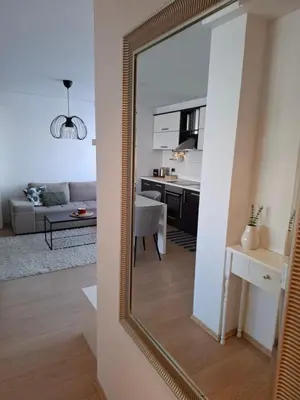 a mirror in a room with a living room at Apartman MAX sa privatnim parkingom in Banja Luka