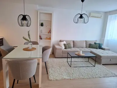 a living room with a table and a couch at Apartman MAX sa privatnim parkingom in Banja Luka