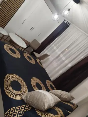 a bedroom with a bed and a window at Apartman Isak in Banja Luka