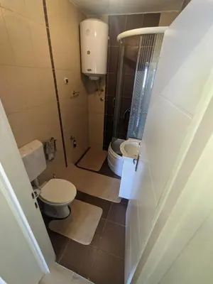 a small bathroom with a toilet and a sink at Apartman Isak in Banja Luka