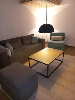a living room with a couch and a coffee table at Apartman Mina in Banja Luka