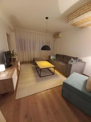 a living room with a couch and a table at Apartman Mina in Banja Luka