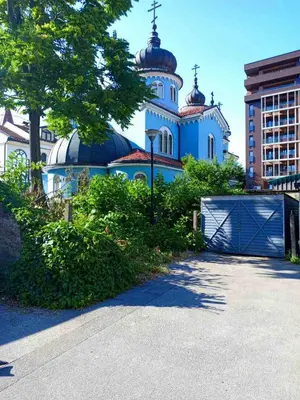 a blue building with a gate in front of it at Apartman Mina in Banja Luka