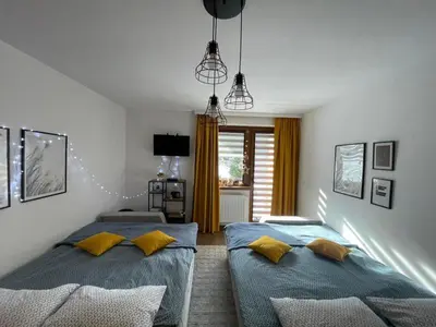 a bedroom with two beds with yellow pillows at Apartman Vlašić Eko Fis 508 in Šišava