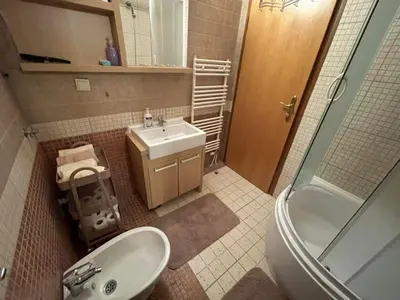 a bathroom with a sink and a toilet and a shower at Apartman Vlašić Eko Fis 508 in Šišava