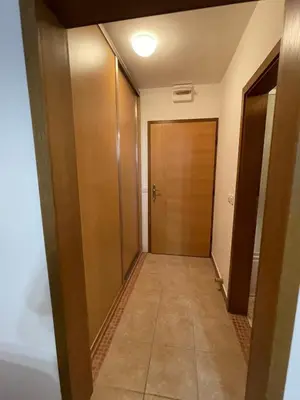 a hallway with a door and a room with a tile floor at Apartman Vlašić Eko Fis 508 in Šišava