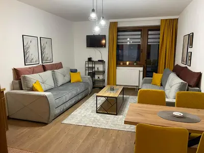 a living room with a couch and a table at Apartman Vlašić Eko Fis 508 in Šišava