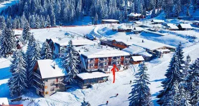 a ski lodge in the snow with snow covered trees at Apartman Vlašić Eko Fis 508 in Šišava