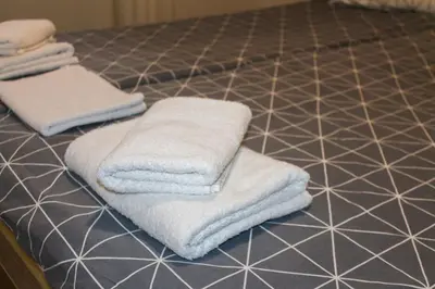 two towels sitting on top of a tiled floor at Apartman Kovačević Vlašić in Vlasic