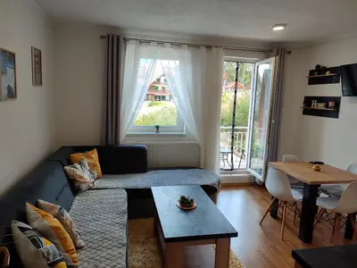a living room with a couch and a table at Apartman Kovačević Vlašić in Vlasic