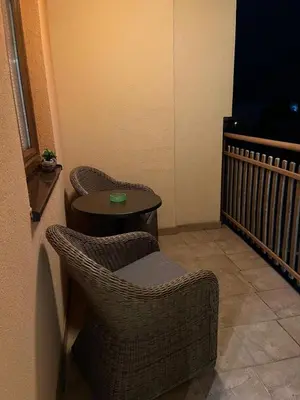 a room with two chairs and a table and a television at Kupres Apartman555 in Kupres