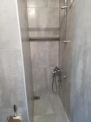 a bathroom with a shower with a toilet in it at studio SM IK 3 in Tomislavgrad