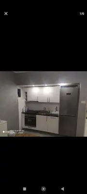 a kitchen with white cabinets and a stainless steel refrigerator at Silvestar-Home house in Zenica