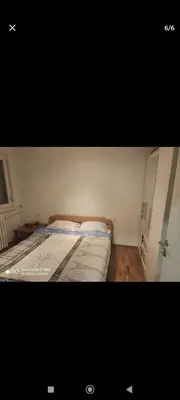 a small bedroom with a bed and a cabinet at Silvestar-Home house in Zenica
