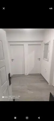 an empty room with two garage doors in a room at Silvestar-Home house in Zenica