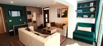 a living room with a couch and a table at Pine Apartment in Travnik