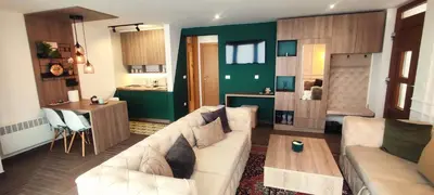 a living room with a couch and a table at Pine Apartment in Travnik