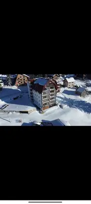 a group of buildings in the snow at Pine Apartment in Travnik