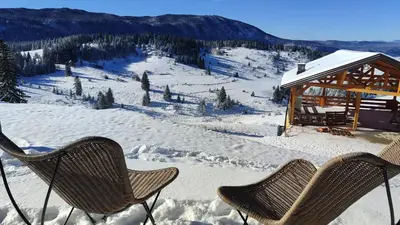 two chairs and a gazebo in the snow at Pine Apartment in Travnik