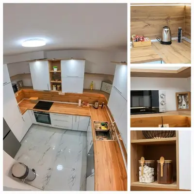 a kitchen with wooden counters and white appliances at Apartman Paradiso in Jajce