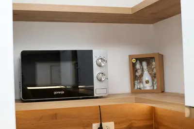 a microwave oven sitting on top of a counter at Apartman Paradiso in Jajce