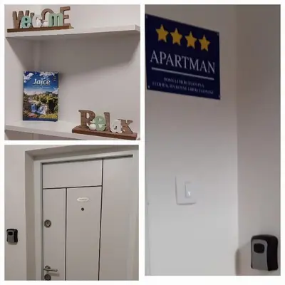 a white door with a sign that says aprventhkin at Apartman Paradiso in Jajce