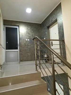 a staircase with a large screen tv in a house at Apartman REINA HOME in Prijedor