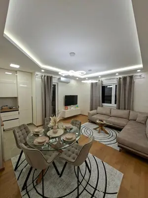 a living room with a table and a couch at Apartman REINA HOME in Prijedor