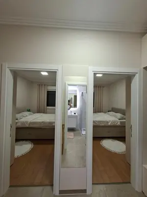 a room with two beds and a mirror at Apartman REINA HOME in Prijedor