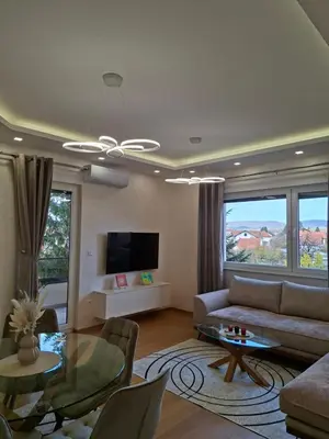 a living room with a couch and a table at Apartman REINA HOME in Prijedor