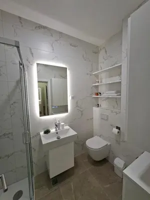 a bathroom with a toilet and a sink and a mirror at Apartman REINA HOME in Prijedor