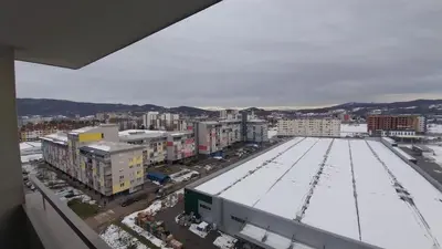 a city with snow on the roofs of buildings at Luka Opal in Doboj