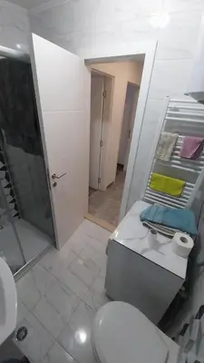 a bathroom with a toilet and a sink and a mirror at Luka Opal in Doboj